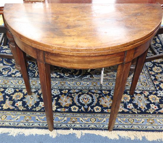 A George III demi lune mahogany tea table W.88cm